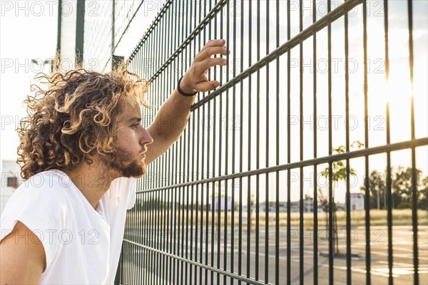 Man looking through fence