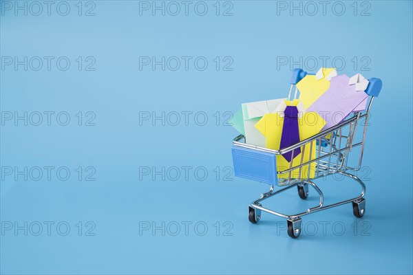 Colourful toy paper shirts supermarket cart