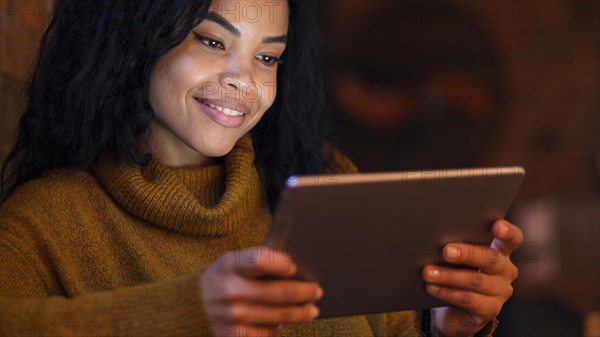 Young woman using tablet coffee shop