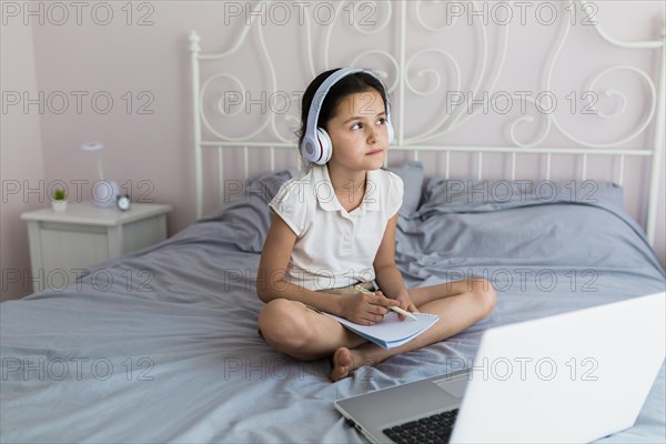 Lovely little girl using her laptop