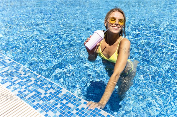 Happy woman posing pool