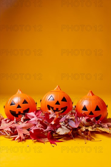 Halloween orange pumpkins on a yellow background