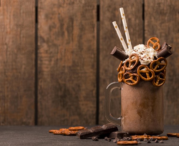 Front view chocolate milkshake with pretzels copy space