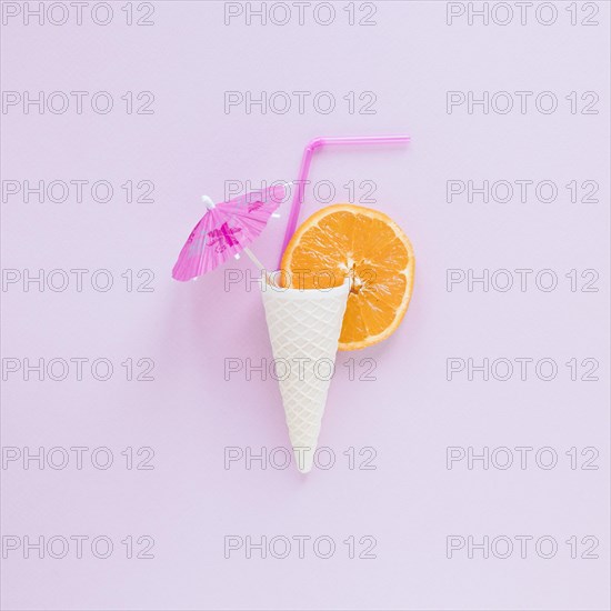 Waffle cone with orange straw umbrella table