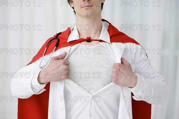 Close up man tearing lab coat