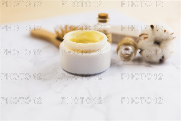 Close up beauty cream bottle cotton flower plant