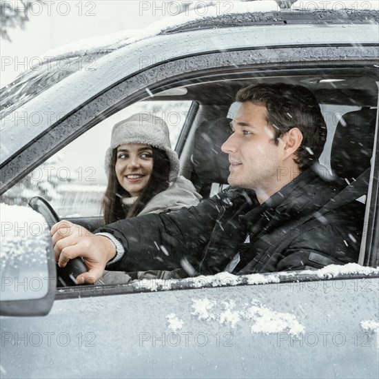 Side view couple together car while road trip