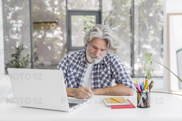 Teacher staying desk writing notebook