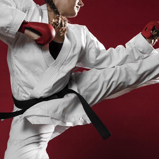 Woman jumping with box gloves red background