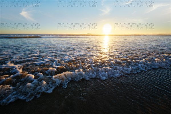 Atlantic ocean sunset with surging waves at Fonte da Telha beach