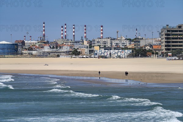 On the beach of Matosinhos on the Atlantic Ocean and oil refinery