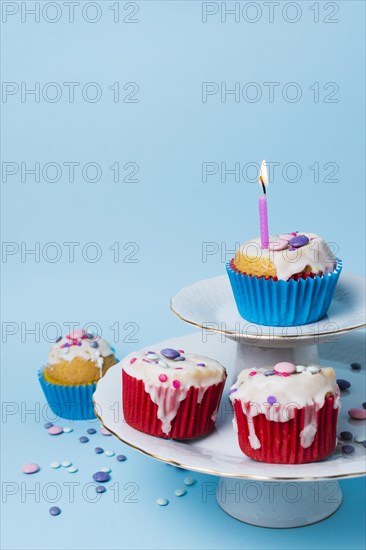 Birthday cupcakes arrangement blue background