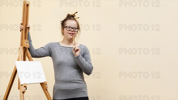 Front view girl down syndrome posing easel