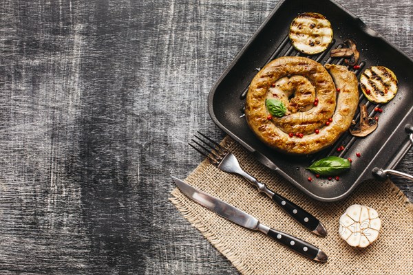 Tasty snail sausage garnish with red peppercorn basil