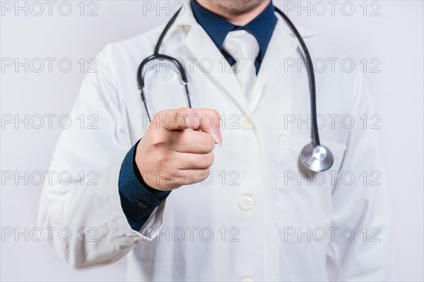 Unrecognizable doctor pointing at the camera. Doctor hands pointing at you isolated