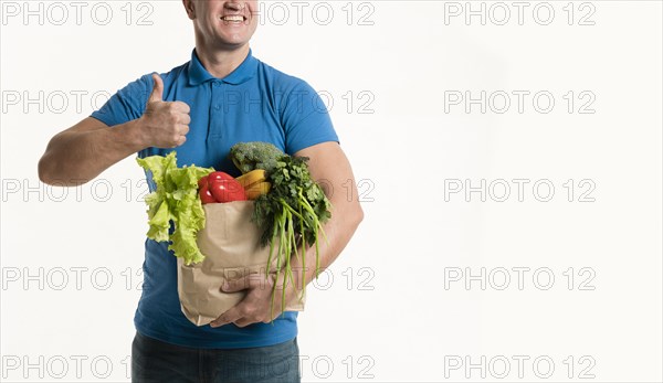 Front view delivery man with grocery bag thumbs up