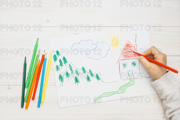 Human hand painting hand drawn drawing with red felt tip pen