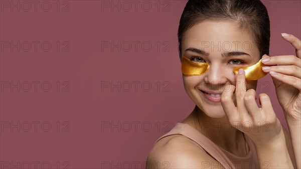 Beautiful woman using eye patch masks