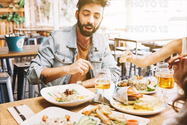 Man eating different dishes food