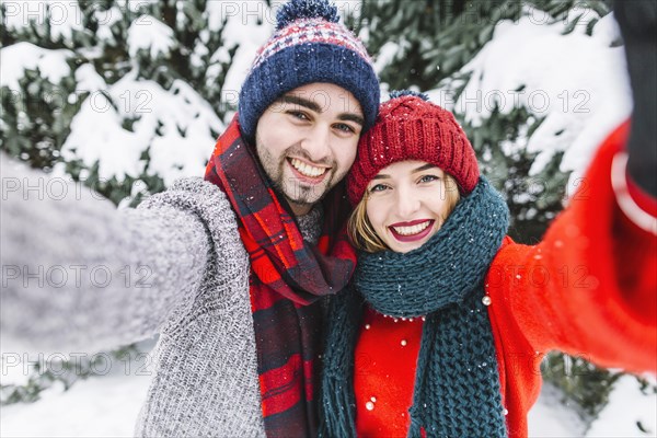 Trendy couple posing camera winter