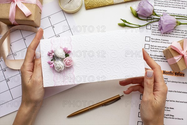 Feminine hands holding wedding envelope