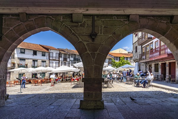 Restaurants at the Praca de Sao Tiago square and the columns of the former town hall in the old town of Guimaraes