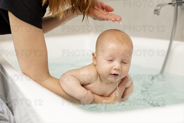 Close up mother washing her baby