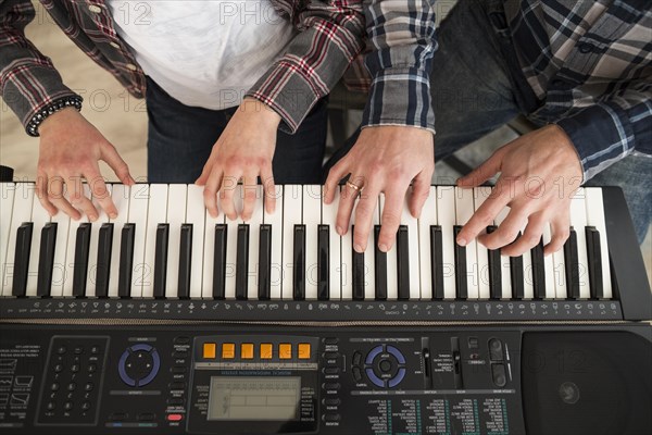 Father daughter playing piano