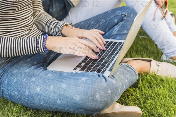 Woman s hand using laptop park