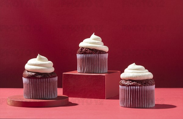 Cupcakes with cream red background