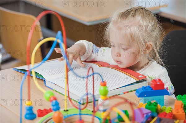 Cute toddler reading book