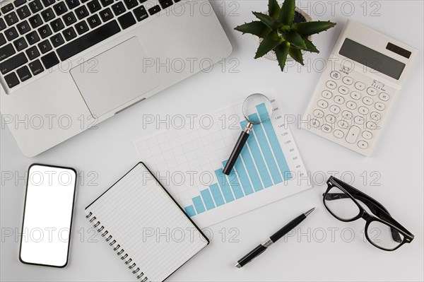 Top view office desk with growth chart