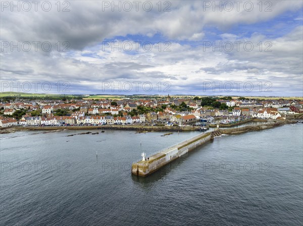 Aerial view of the fishing village of Pittenweem on the Firth of Forth with quay wall and lighthouse