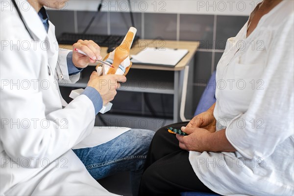 Doctor hands showing bone joints patient