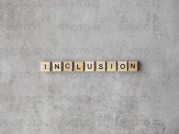 Inclusion word written scrabble letters marble background