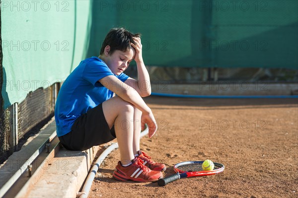 Sideways kid sitting after game