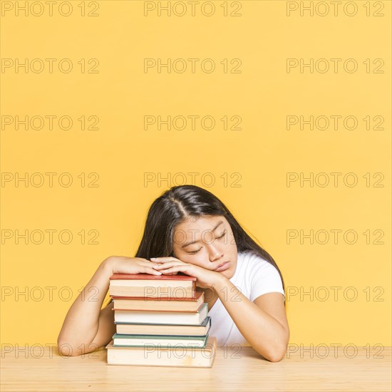 Woman sleeping pile books