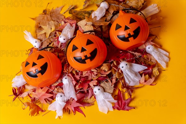 Overhead view of orange Halloween pumpkins on a background of yellow