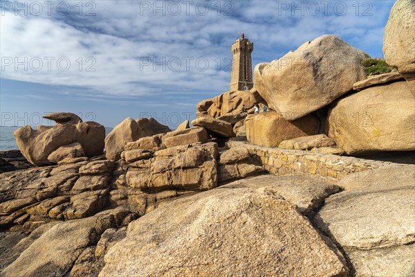 The rocks of the pink granite coast Cote de Granit Rose and the lighthouse Phare de Ploumanac'h near Ploumanac'h