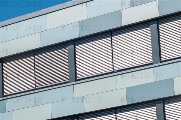 Modern office building with windows and awnings