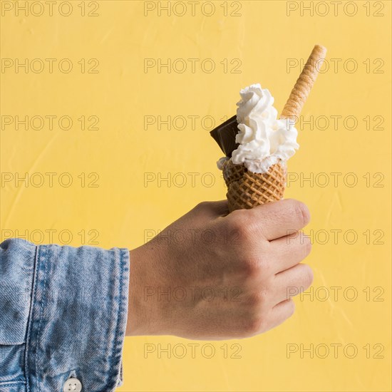 Fresh ice cream with chocolate cone hand