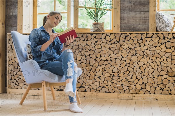 Classy young woman looking book