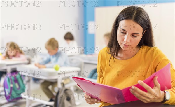 Teacher looking through her notes