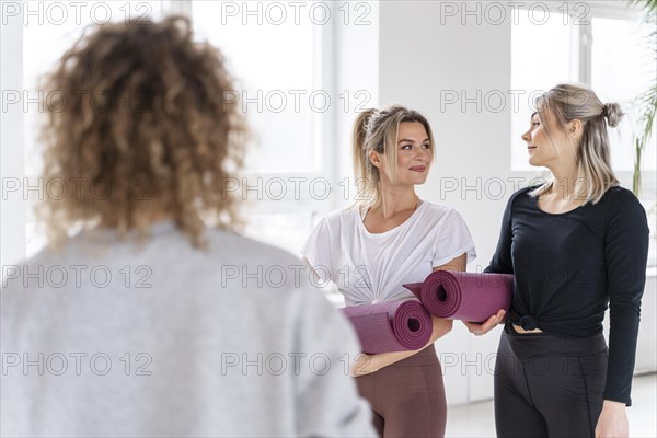 Women holding yoga mats