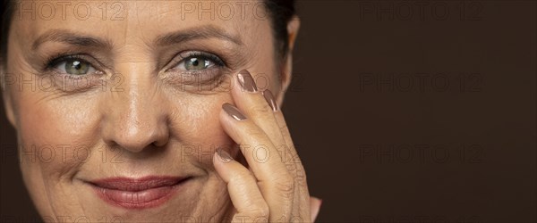 Smiley older woman posing with make up
