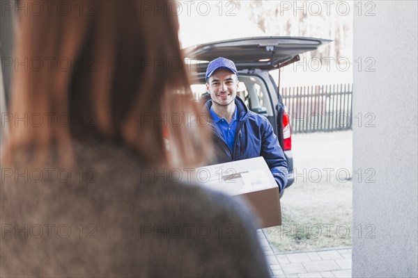 Woman greeting deliveryman porch