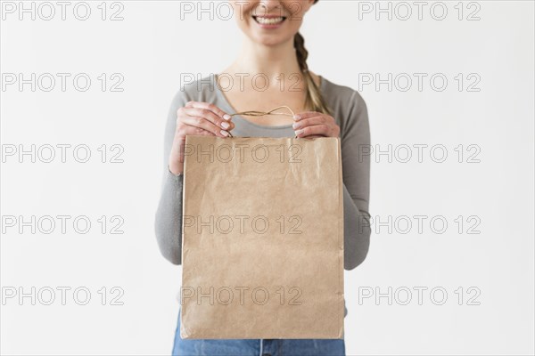Close up woman holding paper bag with groceries