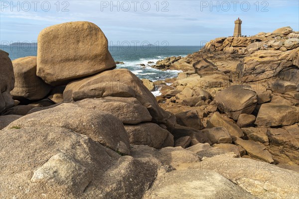 The rocks of the pink granite coast Cote de Granit Rose and the lighthouse Phare de Ploumanac'h near Ploumanac'h