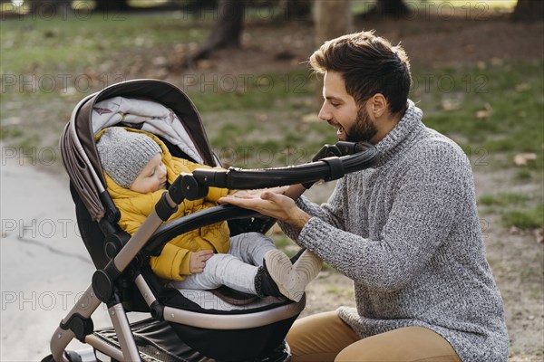 Dad child stroller outdoors nature