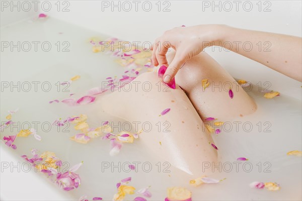 Woman relaxing bath with flowers
